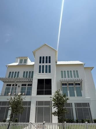 Tall white three-story coastal home